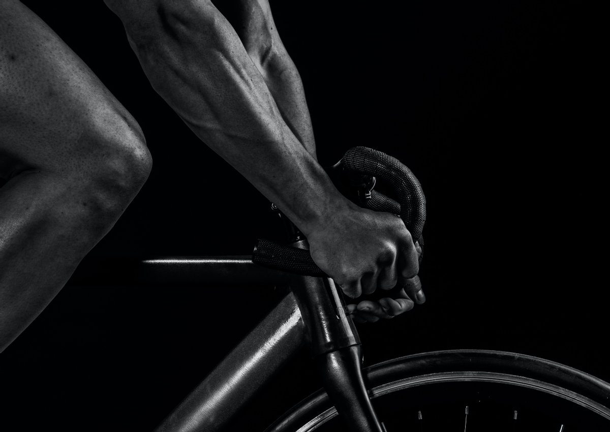 greyscale image of a cyclist from the side